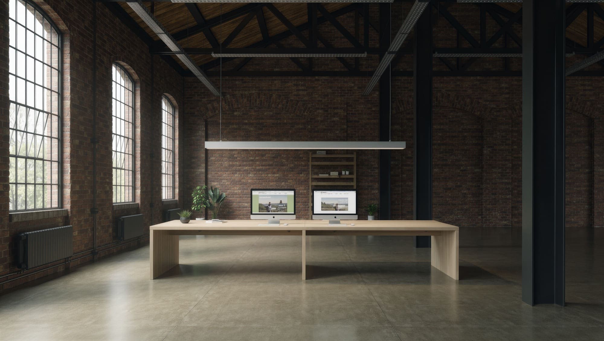 The Right Click UK studio - a long oak desk in a converted brick mill